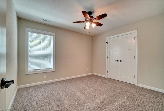 spare room with carpet flooring and ceiling fan