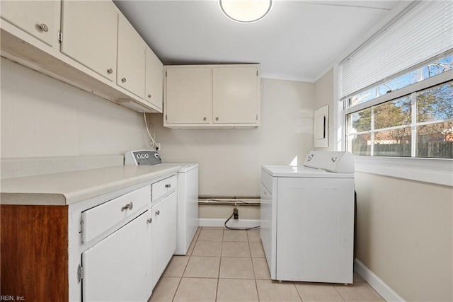 washroom with cabinets, independent washer and dryer, light tile patterned floors, and crown molding