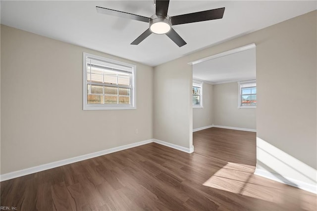 spare room with dark hardwood / wood-style floors and ceiling fan