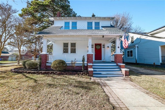 bungalow featuring a porch and a front yard