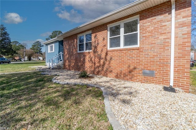 view of side of home with a yard