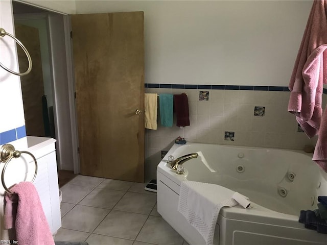 bathroom with tile patterned floors and a washtub