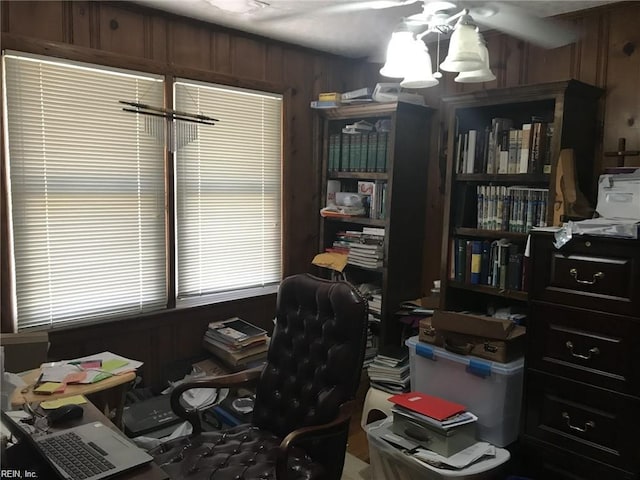 office with wood walls and an inviting chandelier