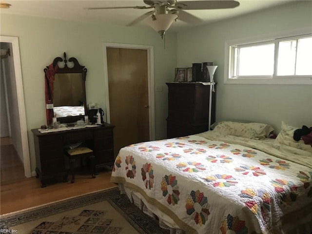 bedroom with ceiling fan and hardwood / wood-style flooring