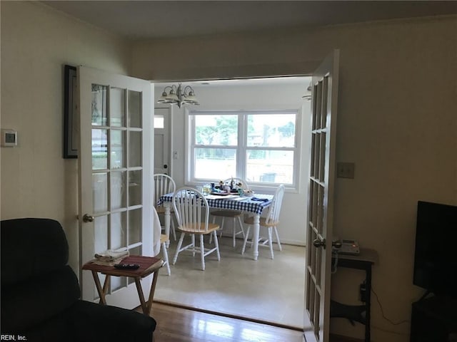 dining room with a chandelier, french doors, and hardwood / wood-style floors