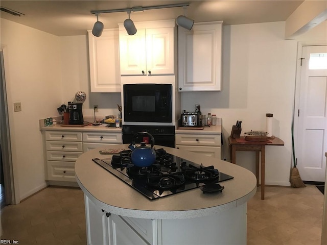 kitchen featuring white cabinets and black appliances