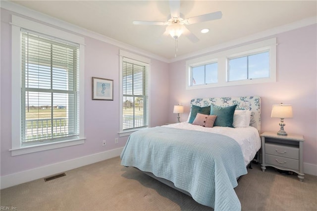 bedroom featuring light carpet, ceiling fan, and ornamental molding