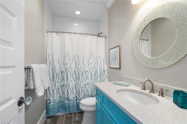 bathroom with toilet, vanity, a shower with shower curtain, and hardwood / wood-style flooring