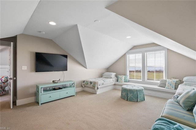 bedroom featuring light colored carpet and vaulted ceiling