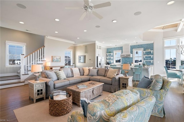 living room with a healthy amount of sunlight, ceiling fan, crown molding, and wood-type flooring