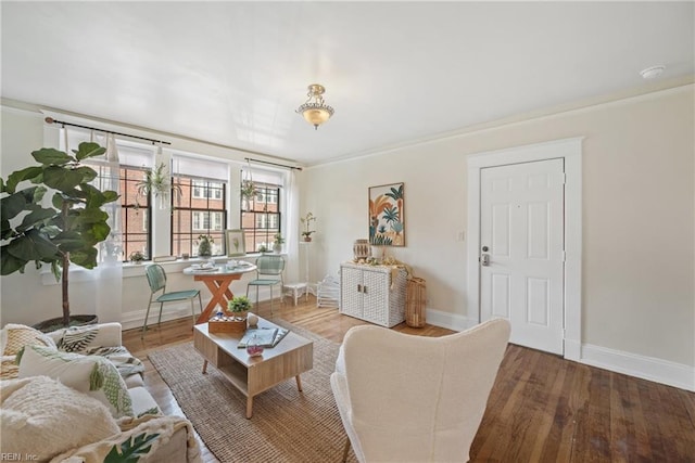 sitting room with hardwood / wood-style floors and crown molding