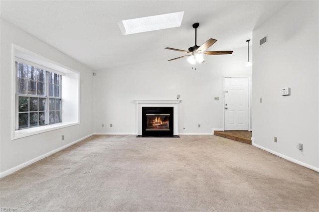 unfurnished living room featuring light colored carpet and ceiling fan