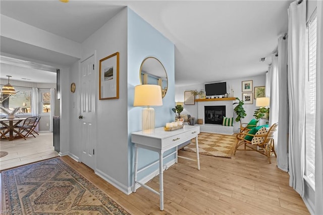 hallway with light hardwood / wood-style floors