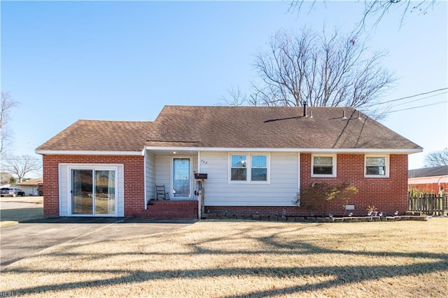 rear view of house featuring a yard