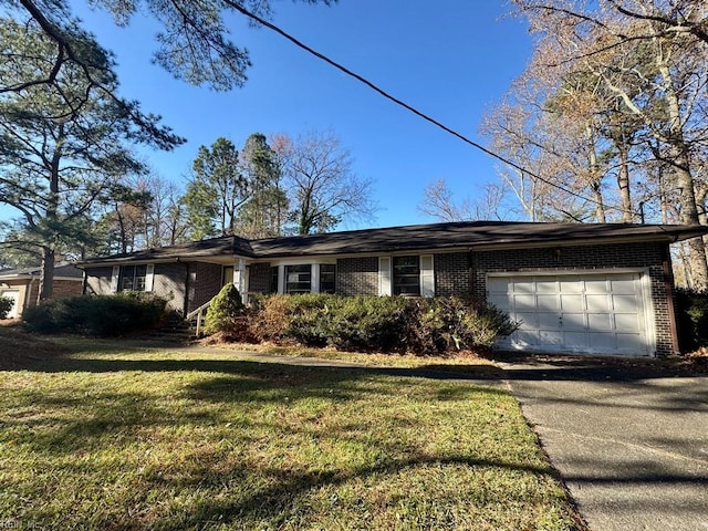 ranch-style home with a garage and a front lawn