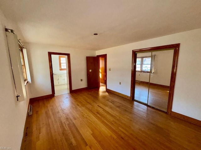 empty room with hardwood / wood-style flooring