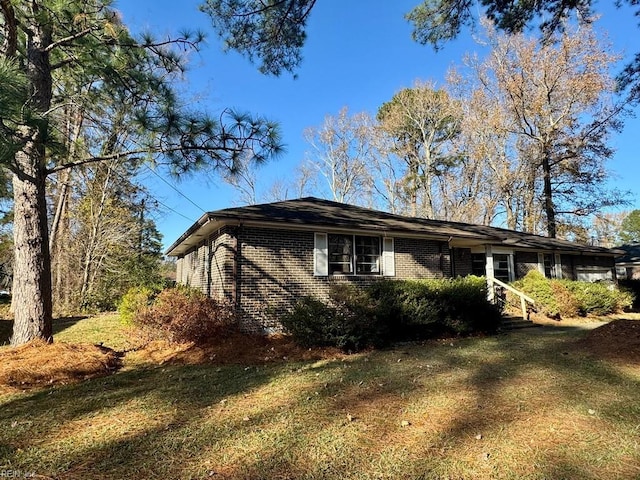 view of side of home featuring a lawn