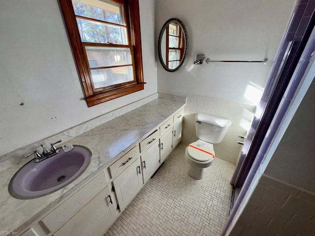 bathroom featuring tile patterned flooring, vanity, and toilet