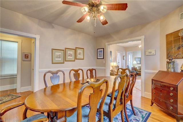 dining space with light hardwood / wood-style floors and ceiling fan