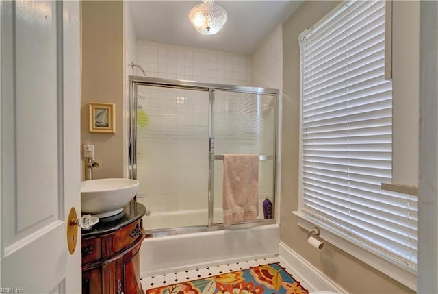 bathroom with vanity and bath / shower combo with glass door