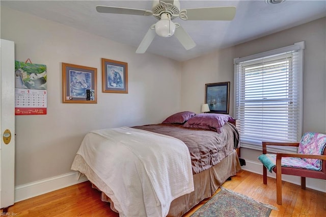 bedroom with ceiling fan and light hardwood / wood-style flooring