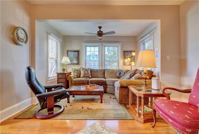 living room featuring hardwood / wood-style floors and ceiling fan