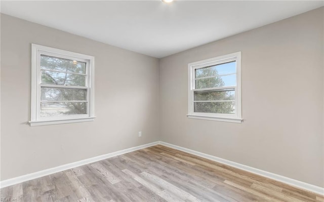 spare room with a healthy amount of sunlight and light hardwood / wood-style floors