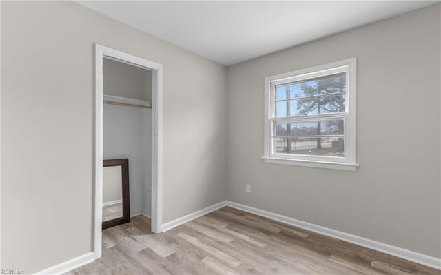 unfurnished bedroom featuring a closet and light hardwood / wood-style flooring