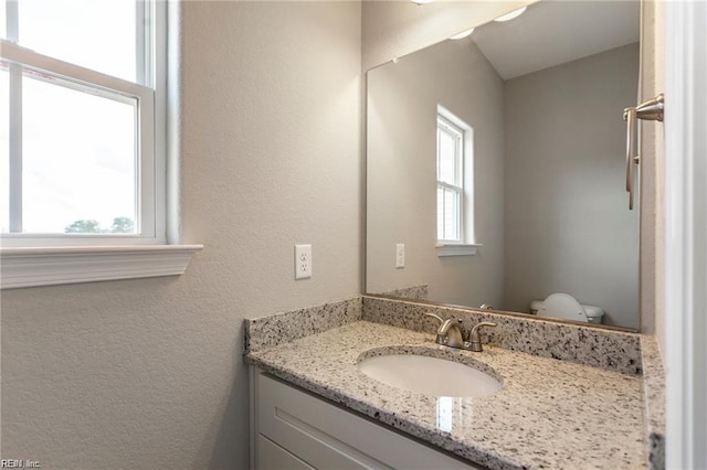 bathroom with vanity and toilet