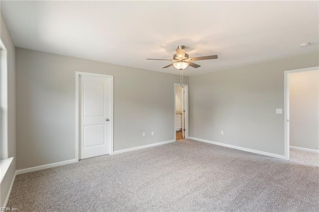 empty room featuring ceiling fan and carpet floors