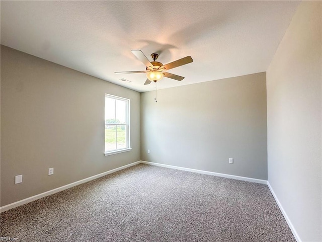 carpeted empty room featuring ceiling fan