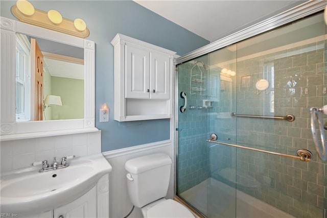 bathroom with decorative backsplash, toilet, vanity, and walk in shower