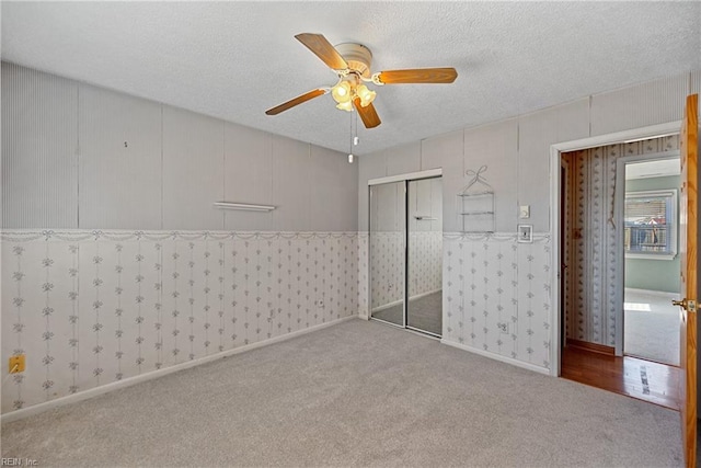 unfurnished bedroom with carpet flooring, a closet, and ceiling fan