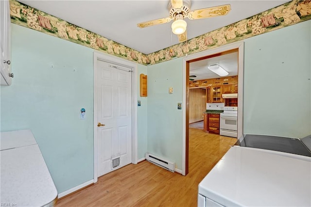 washroom with ceiling fan, light hardwood / wood-style flooring, and a baseboard radiator