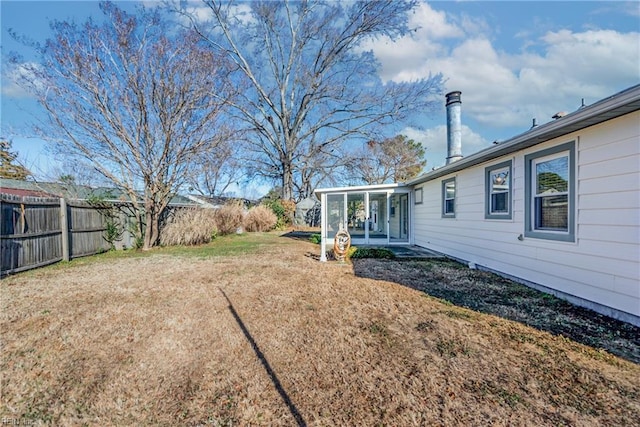 view of yard featuring a sunroom and a patio