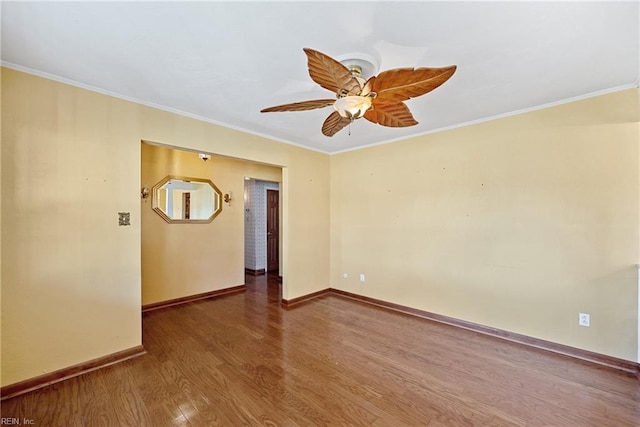 empty room with hardwood / wood-style flooring, ceiling fan, and crown molding