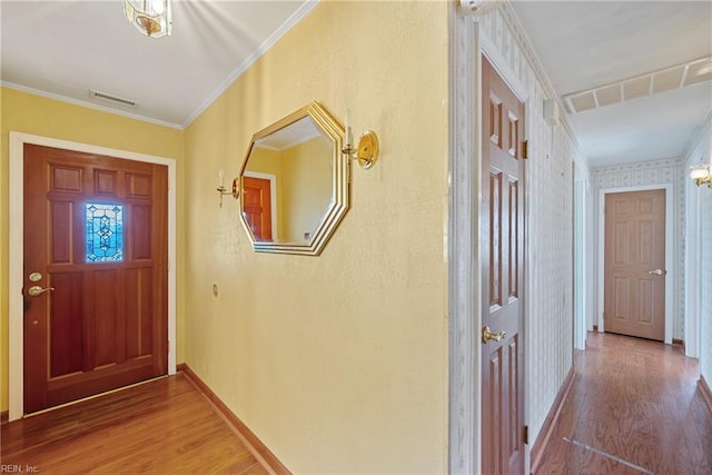 entrance foyer featuring hardwood / wood-style floors and ornamental molding