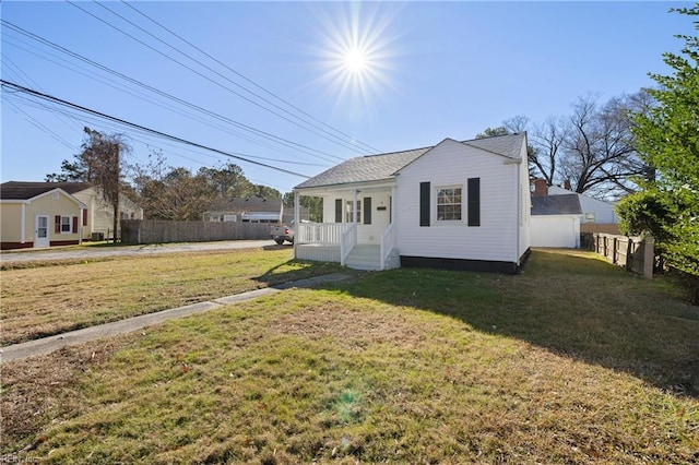 view of front of property with covered porch and a front yard