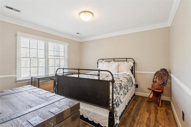 bedroom with dark hardwood / wood-style floors and ornamental molding