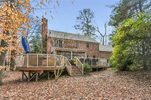 rear view of house featuring a deck