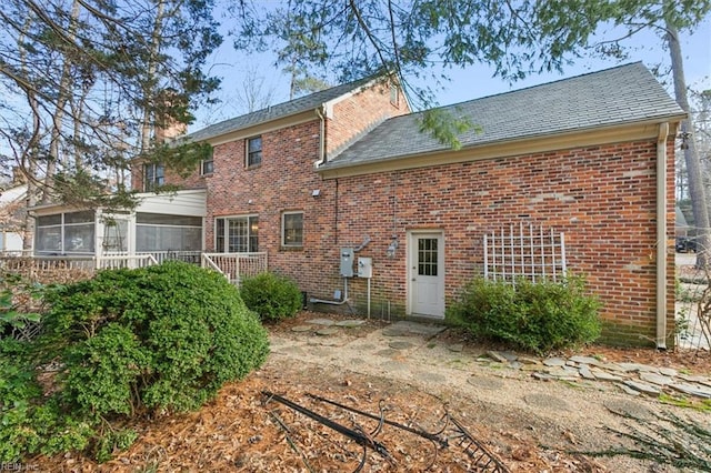 back of house featuring a sunroom