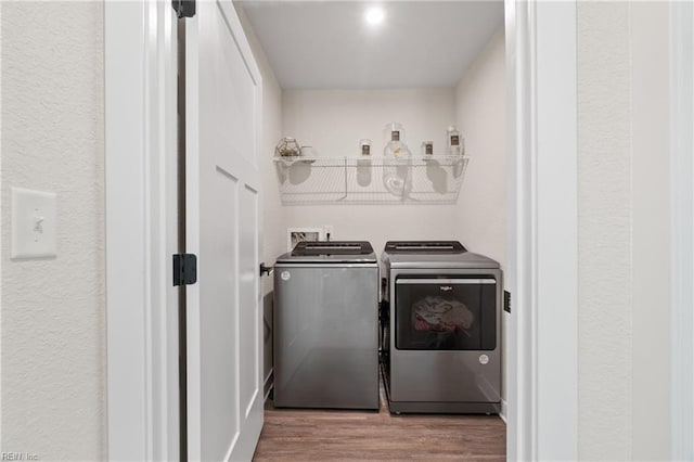 washroom with washer and dryer and hardwood / wood-style flooring