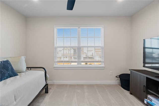 carpeted bedroom featuring ceiling fan and multiple windows