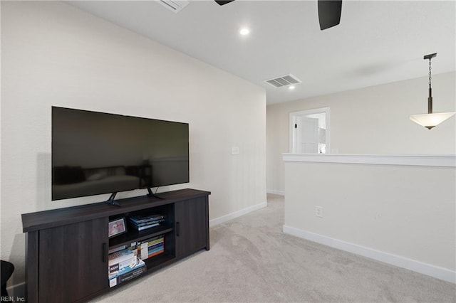 carpeted living room with ceiling fan