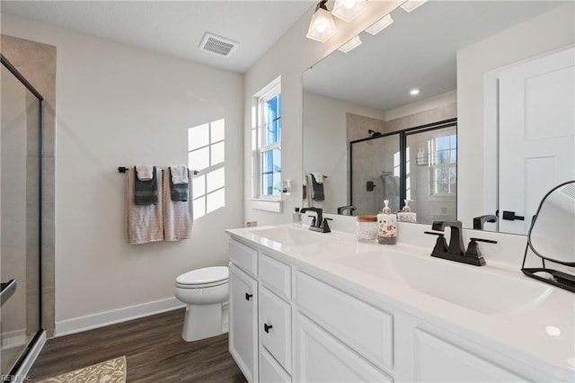 bathroom featuring toilet, a shower with door, wood-type flooring, and vanity