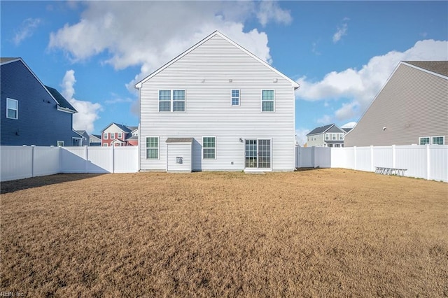 rear view of house featuring a lawn