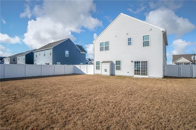 rear view of house with a yard