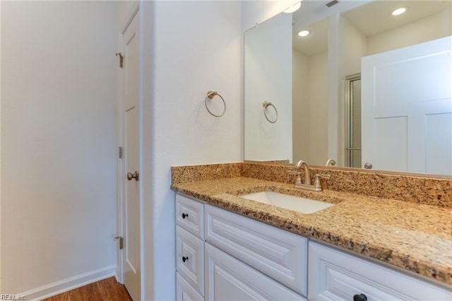 bathroom with hardwood / wood-style floors and vanity