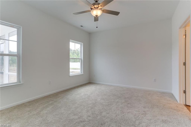 spare room featuring ceiling fan and light colored carpet