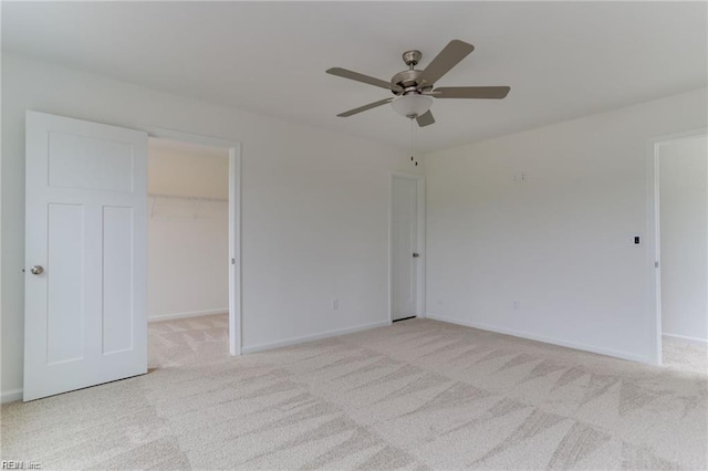 unfurnished room with light colored carpet and ceiling fan